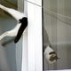 Illustration for article titled Video: Man Rescues Cat Stuck In Window